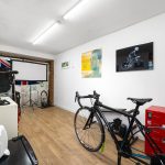 Bike workshop with tools and cycling posters.