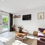 Modern living room with garden view and cosy sofa.