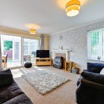 Bright living room with large window and modern decor.