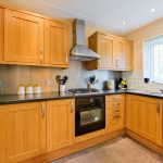 Modern kitchen with wooden cabinets and appliances.
