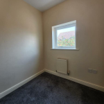 Small room with window and radiator.