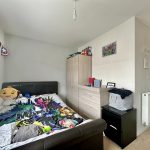Bedroom with superhero-themed decor and bedding.