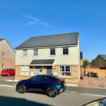 Modern suburban house with two parked cars.