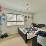 Messy bedroom with superhero decorations and toys