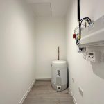 Utility room with boiler and electrical panel.