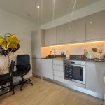 Modern kitchen with flowers and star-shaped balloons.