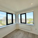 Bright room with large windows and city view.