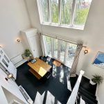Bright dining area with large windows and garden view.