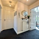 Bright hallway with open doors and decor.