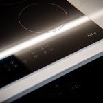 Black induction hob with touch controls.