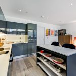 Modern open-plan kitchen and living room design.