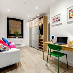 Modern home office with colourful decor and artwork.