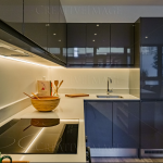 Modern kitchen with sleek black cabinets and appliances.
