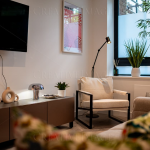 Modern living room with plants and wall art.