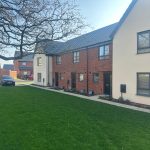 Modern UK houses with grassy front garden.