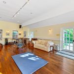 Spacious living room with drum set and sofa.