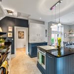 Modern kitchen with island and dining area.