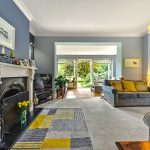 Cosy living room with fireplace and garden view.