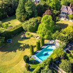 Aerial view of garden, pool, and house