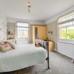 Cosy bedroom with double bed and light decor.