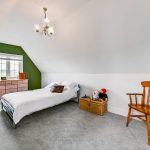 Cosy attic bedroom with wooden furniture and toys