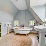 Cosy bathroom with freestanding tub and sink.