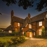 Charming brick house under starlit evening sky.