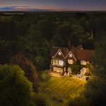 Aerial view of house at dusk in countryside