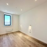 Minimalist room with wooden flooring and window