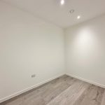 Empty room with wooden floor and white walls.