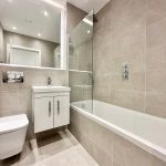 Modern bathroom with bathtub and mirror