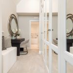 Modern dressing room with mirrored wardrobes and desk