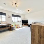 Modern living room with wooden furniture and toys.
