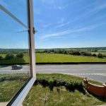 View of countryside from open window