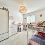 Child's bedroom with bunk bed and colourful decor.