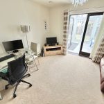Modern home office with desk and computer setup.