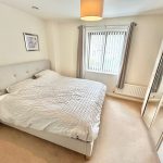 Bright bedroom with double bed and window