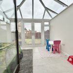 Conservatory with children's furniture and toys.