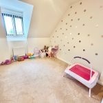 Children's room with toys and doll crib.