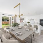 Modern dining room and kitchen with garden view.