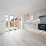 Modern kitchen with patio doors to garden.