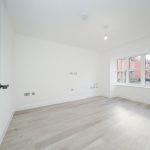 Empty room with wooden floor and large window