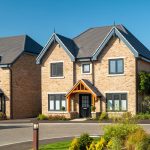 Modern detached house with brick facade and garden