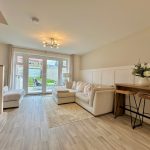 Modern living room with garden view and seating area.