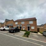 Modern brick houses with driveways in residential area.