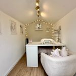 Cosy nail salon room with decorative lights.