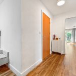 Modern hallway with wooden flooring and natural light