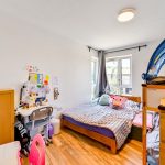 Children's bedroom with bunk bed and desk.