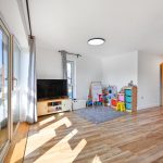 Bright living room with children's play area.