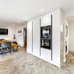 Modern kitchen diner with herringbone floor.